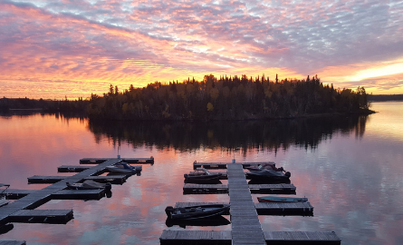 Docking on a lake with sunset over an island